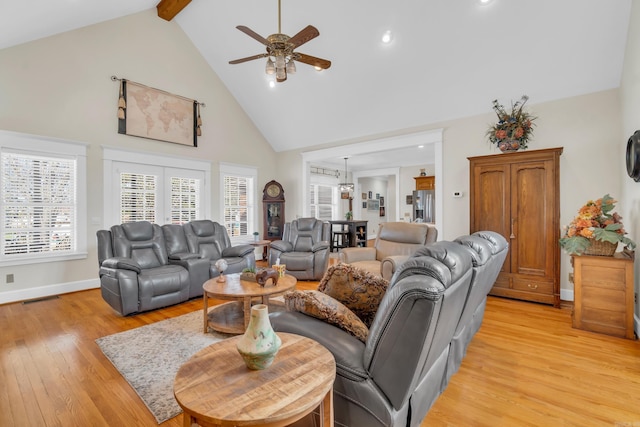 living room featuring visible vents, a healthy amount of sunlight, ceiling fan, and light wood-style flooring