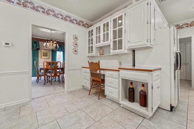 kitchen featuring built in desk, open shelves, white cabinetry, and ornamental molding