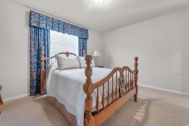 bedroom with baseboards and carpet floors