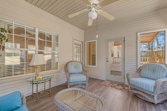 sunroom with wooden ceiling and a ceiling fan