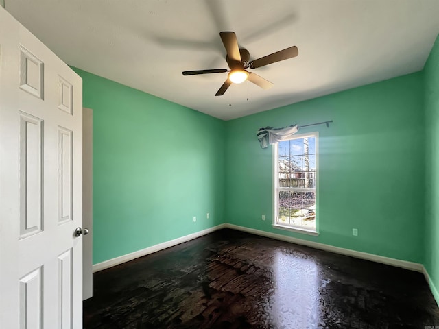 unfurnished room featuring baseboards and ceiling fan