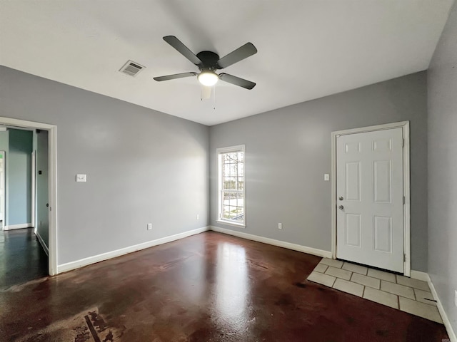 entryway with finished concrete floors, a ceiling fan, visible vents, and baseboards