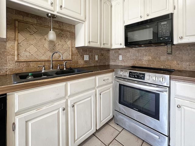 kitchen featuring dark countertops, tasteful backsplash, black microwave, stainless steel electric range oven, and a sink