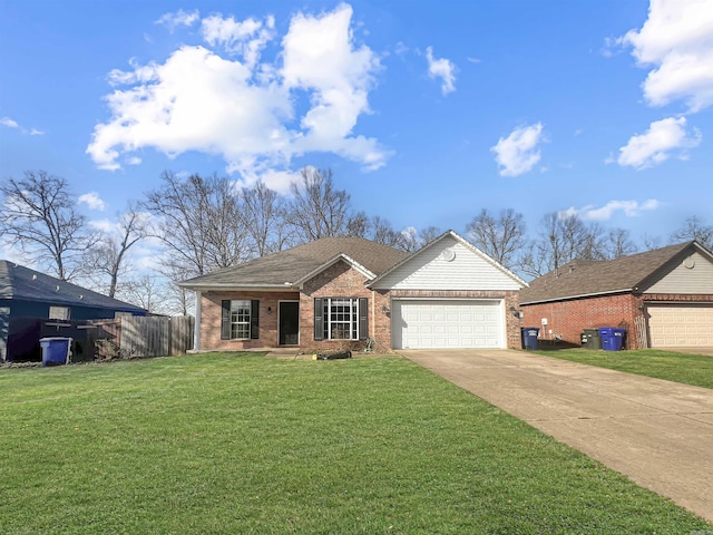 view of front of property with a front yard, fence, an attached garage, concrete driveway, and brick siding