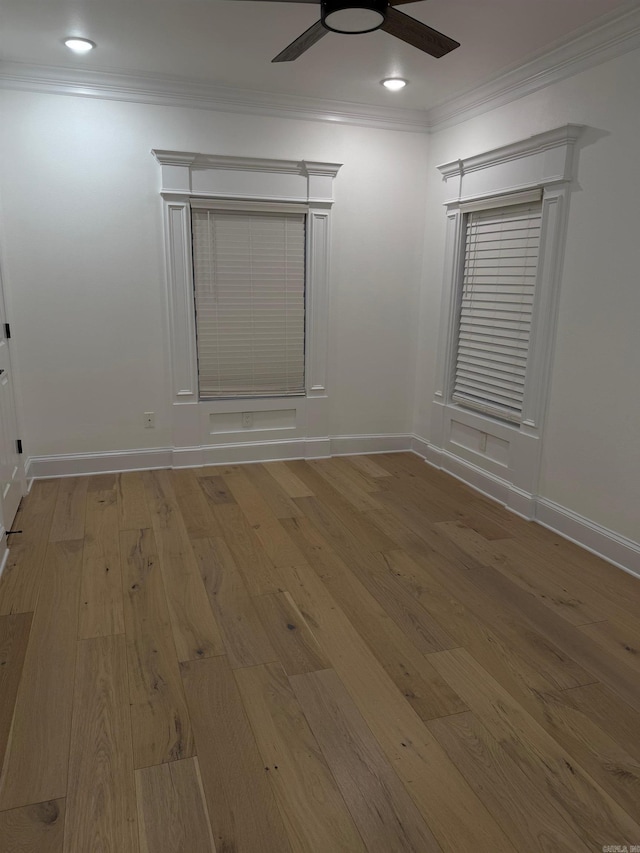 empty room featuring baseboards, recessed lighting, ceiling fan, wood-type flooring, and crown molding