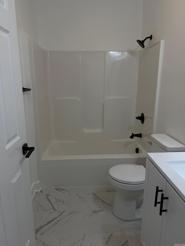 full bathroom featuring vanity, shower / tub combination, toilet, and marble finish floor