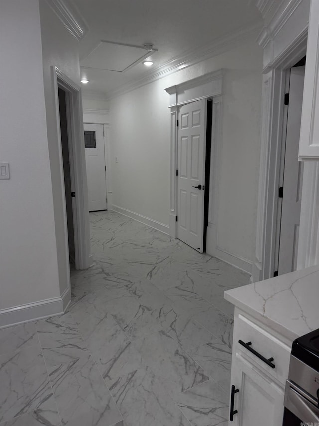 corridor with baseboards, marble finish floor, and ornamental molding