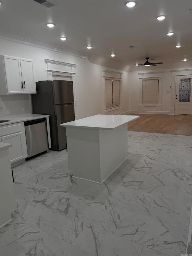 kitchen featuring crown molding, light countertops, recessed lighting, appliances with stainless steel finishes, and a ceiling fan