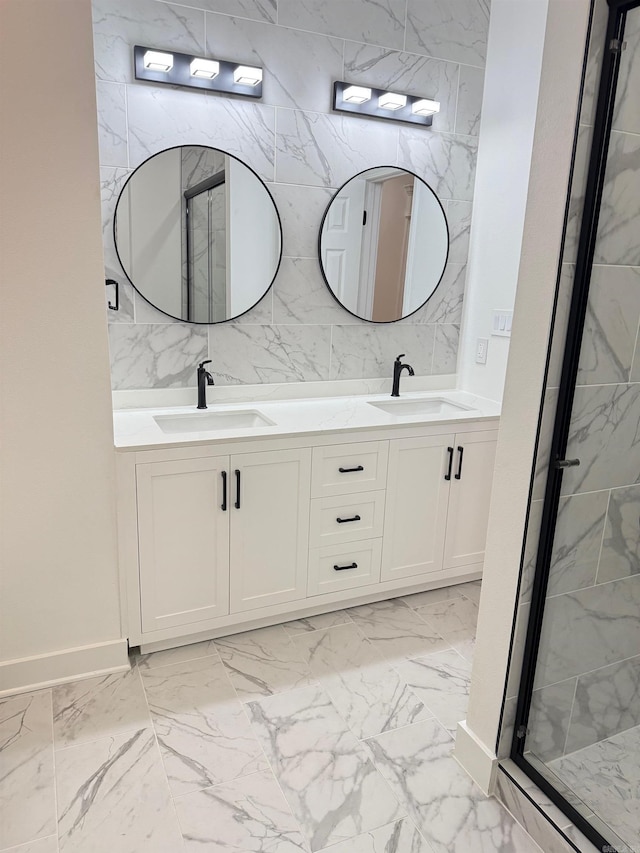 full bathroom featuring a sink, marble finish floor, and a stall shower