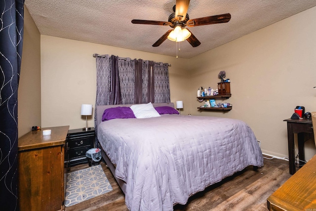 bedroom featuring a textured ceiling, ceiling fan, and wood finished floors