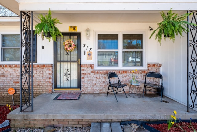 view of exterior entry featuring brick siding