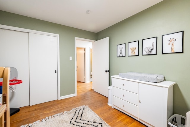 bedroom featuring light wood-style flooring and a closet