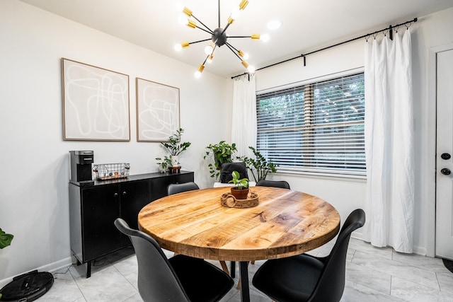 dining area featuring a notable chandelier and baseboards