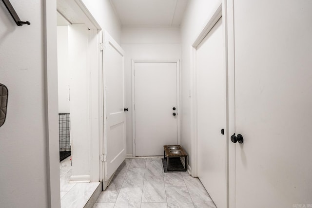 hall featuring marble finish floor