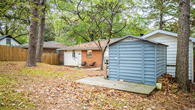 view of shed featuring fence