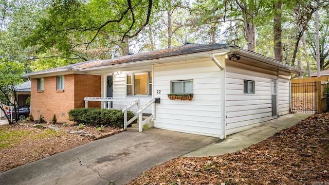 view of front of property with brick siding and fence