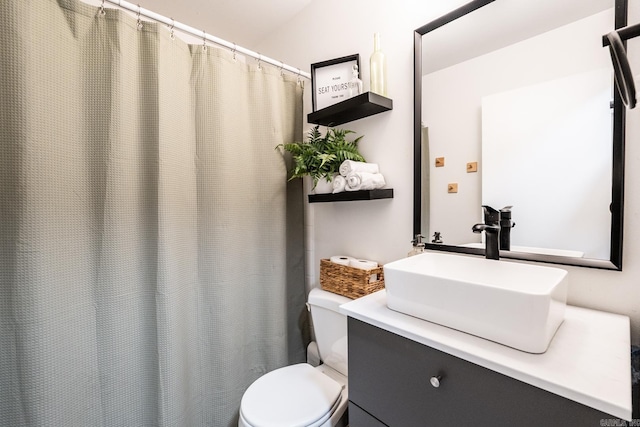 bathroom with toilet and vanity