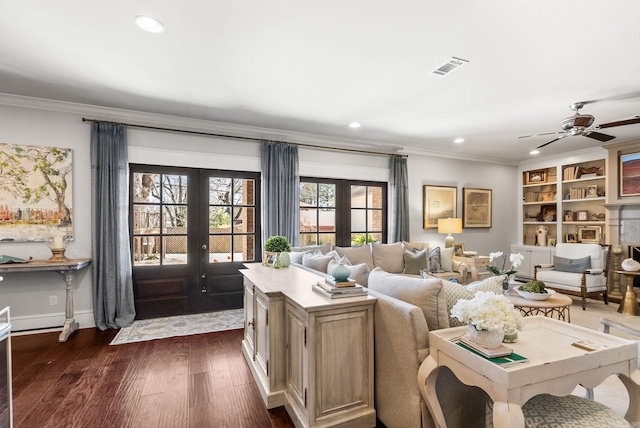 living room featuring dark wood-type flooring, french doors, visible vents, and ornamental molding