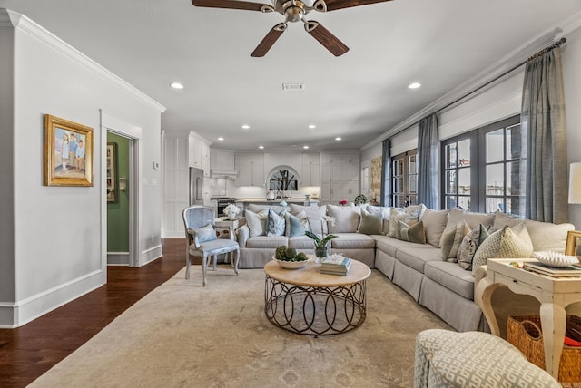 living area with visible vents, recessed lighting, ceiling fan, dark wood-type flooring, and crown molding