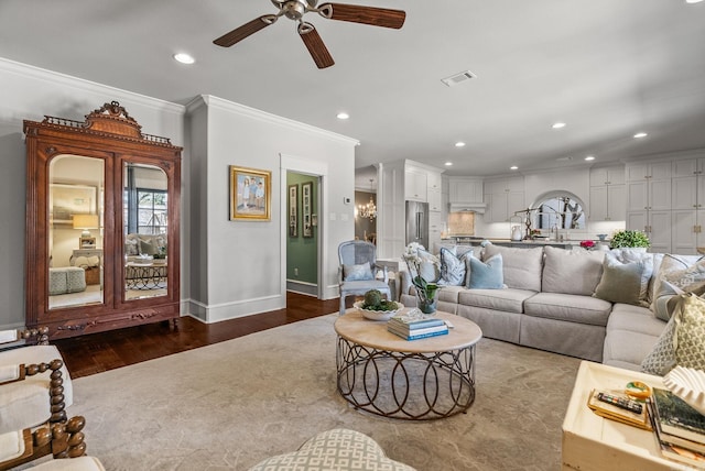 living area featuring visible vents, ornamental molding, a ceiling fan, wood finished floors, and recessed lighting