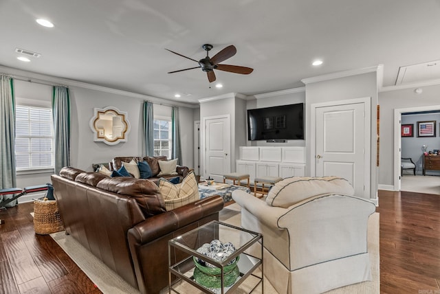 living area featuring visible vents, wood finished floors, ceiling fan, and ornamental molding