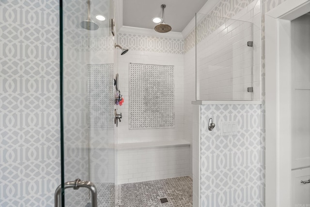 full bathroom featuring crown molding and a tile shower