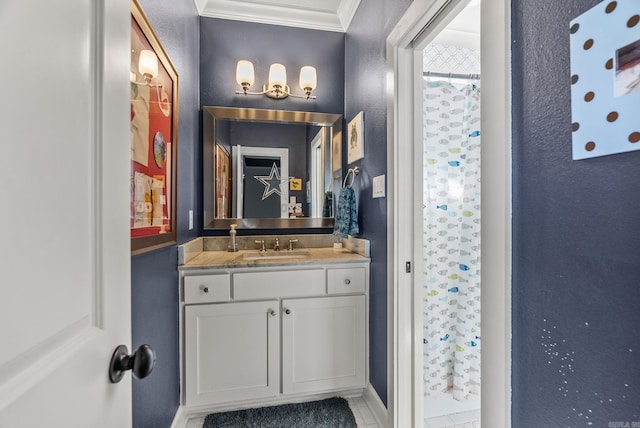 bathroom featuring vanity, a shower with curtain, a textured wall, and ornamental molding