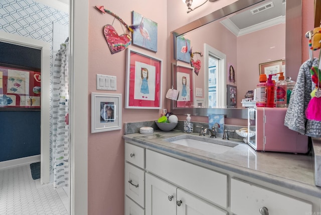 bathroom with tile patterned flooring, visible vents, crown molding, baseboards, and vanity