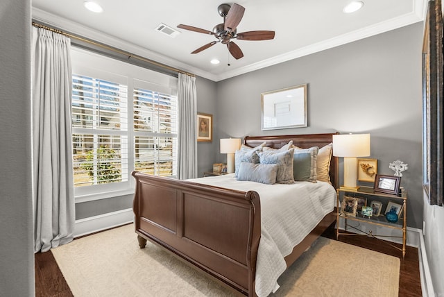 bedroom with visible vents, baseboards, ornamental molding, recessed lighting, and wood finished floors