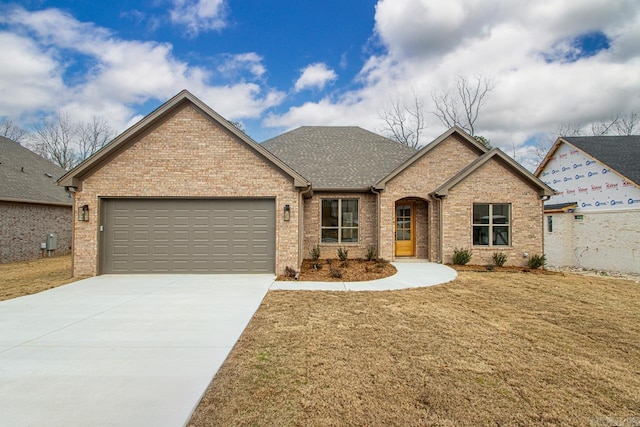 view of front of property featuring a garage, brick siding, concrete driveway, and a front lawn