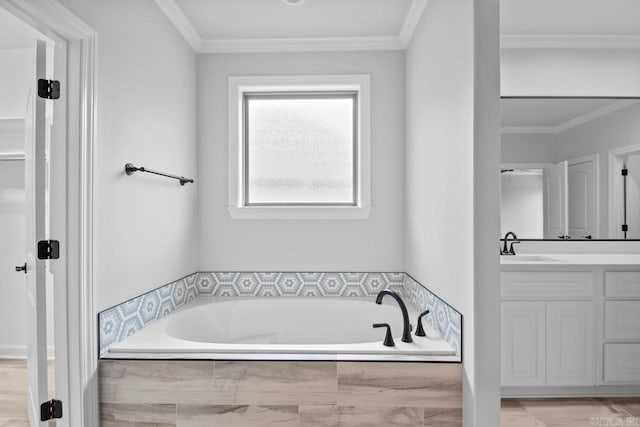 full bathroom featuring vanity, a garden tub, and ornamental molding