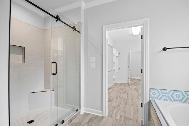 full bath with baseboards, a garden tub, a stall shower, and crown molding