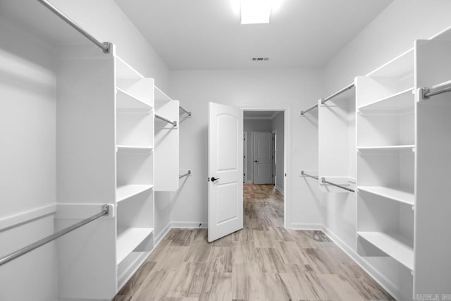 spacious closet featuring light wood-style floors and visible vents