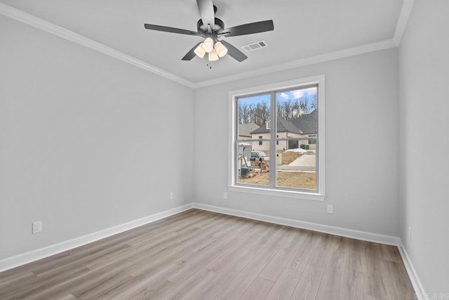 unfurnished room with visible vents, a ceiling fan, wood finished floors, crown molding, and baseboards