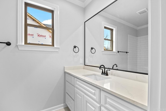 bathroom with visible vents, baseboards, ornamental molding, and vanity