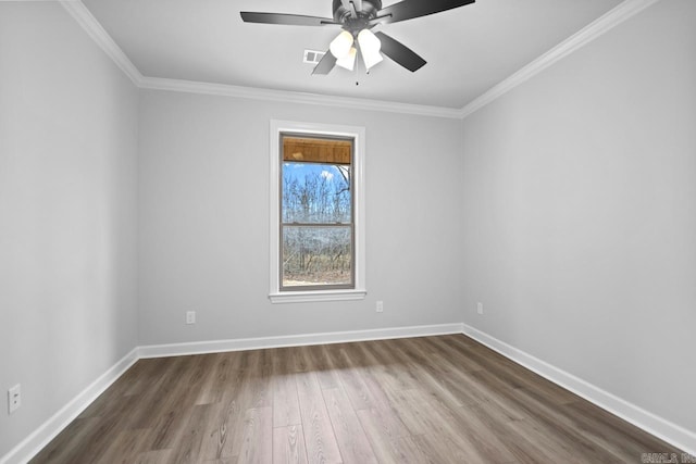 unfurnished room featuring ceiling fan, baseboards, dark wood finished floors, and ornamental molding