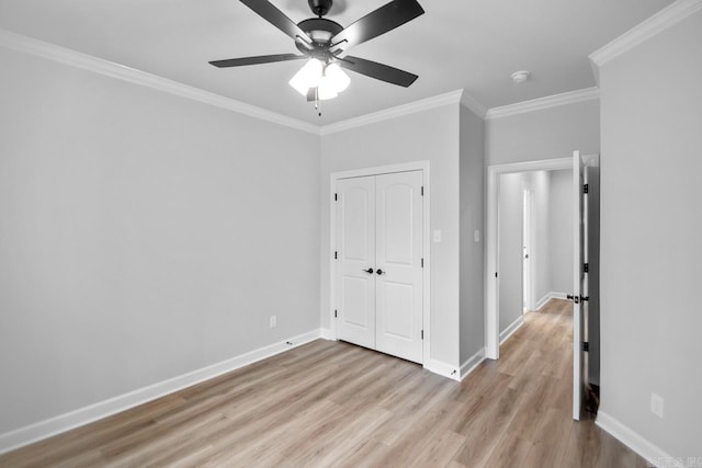 unfurnished bedroom featuring baseboards, light wood-style floors, and crown molding