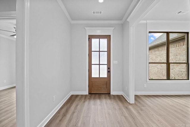 foyer featuring plenty of natural light, visible vents, and ornamental molding