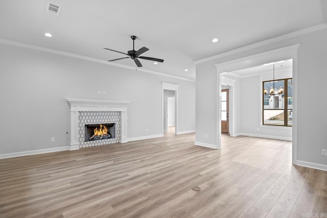 unfurnished living room with visible vents, light wood-style flooring, a tile fireplace, and baseboards