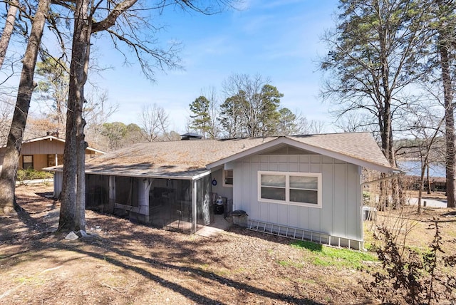 exterior space featuring roof with shingles