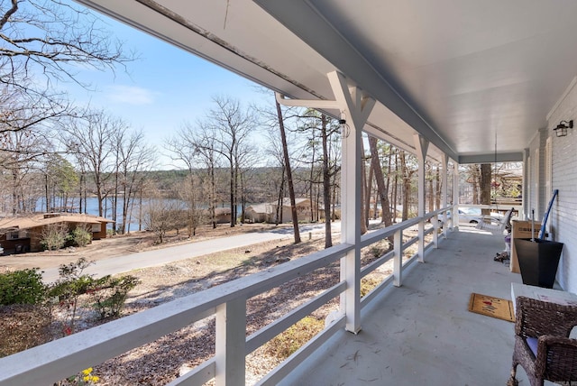 view of patio / terrace with a porch and a water view