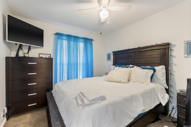 bedroom with carpet floors, a textured ceiling, a ceiling fan, and crown molding