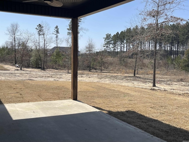 view of yard featuring a ceiling fan and a patio area