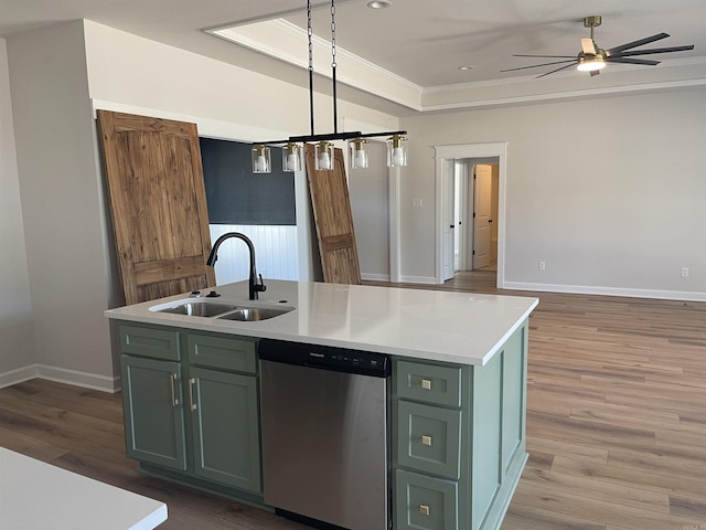 kitchen with light wood-style flooring, a sink, stainless steel dishwasher, green cabinets, and light countertops