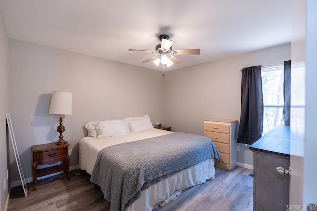 bedroom with baseboards, light wood-style floors, and ceiling fan