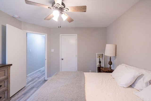 bedroom with light wood finished floors and ceiling fan