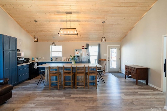 dining space with wooden ceiling, lofted ceiling, and wood finished floors