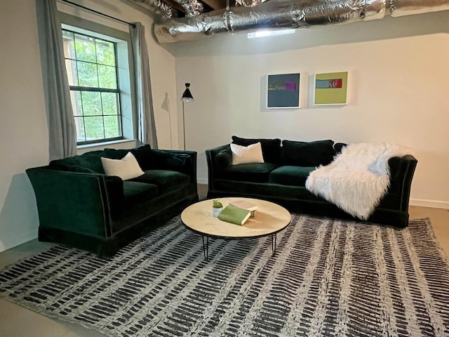 living area featuring baseboards