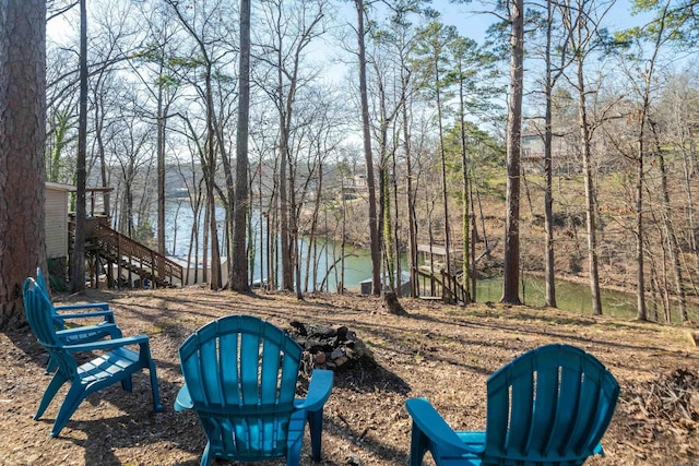 view of yard with stairway and a water view