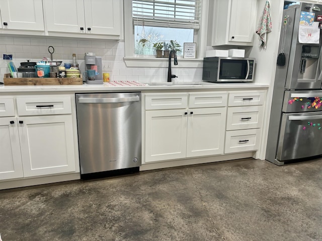 kitchen featuring white cabinetry, light countertops, appliances with stainless steel finishes, and a sink